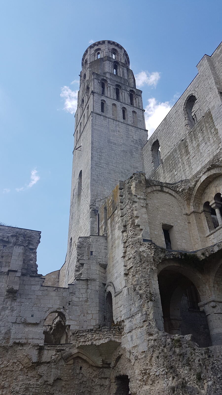 one of the towers of Jumièges Abbey seen from below, among the ruined masonry